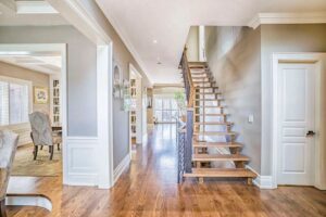 A large open floor plan with wood floors and stairs.