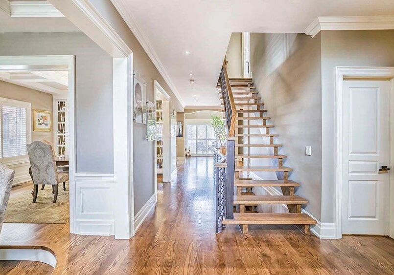 A large open floor plan with wood floors and stairs.